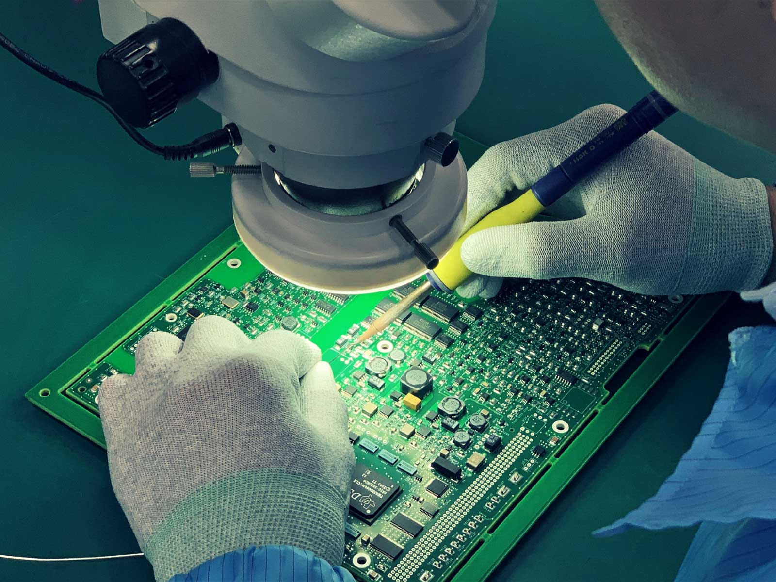 Hands working on a circuit board